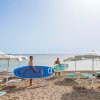 Due persone con tavole da surf sulla spiaggia.